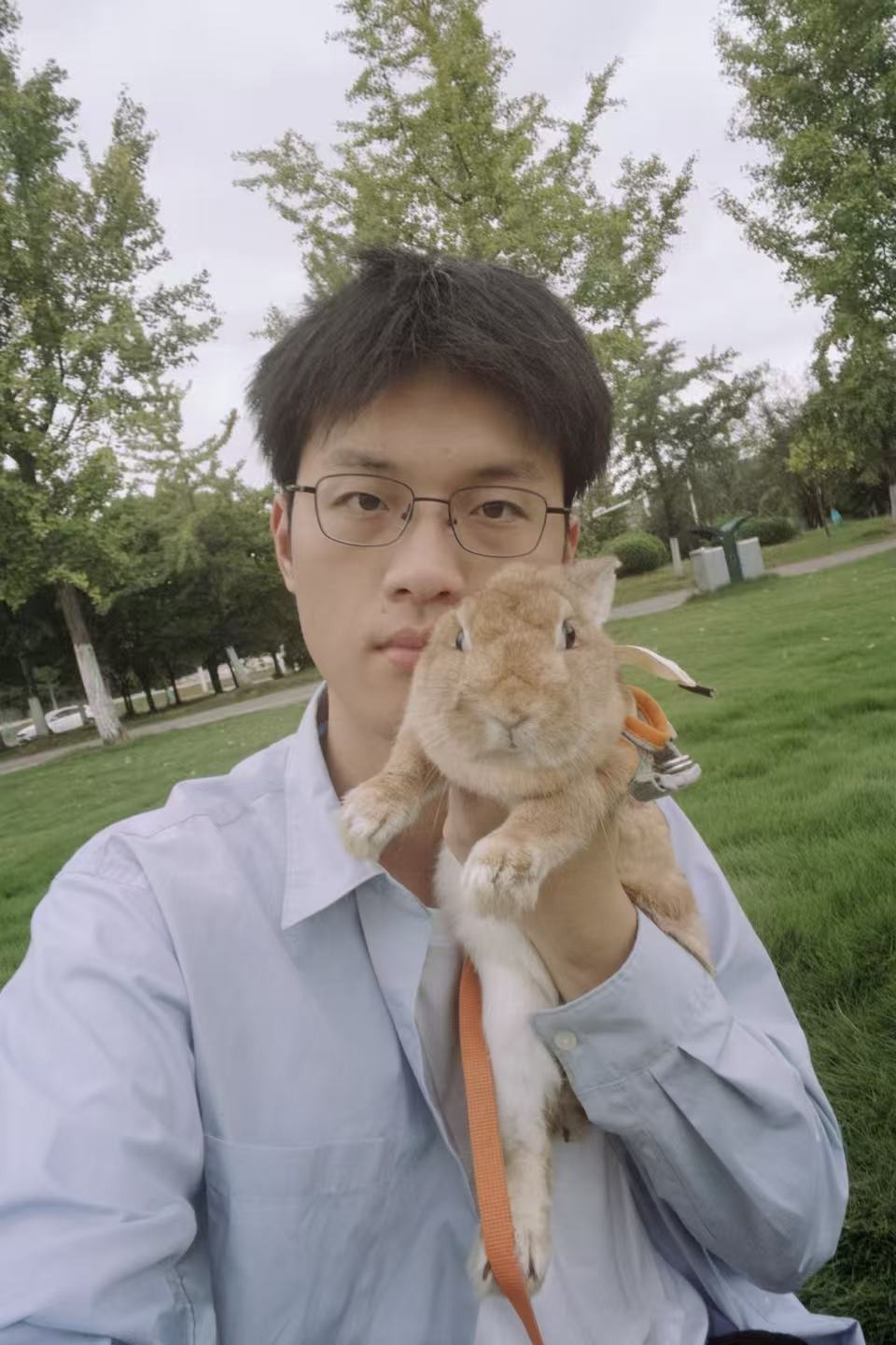 Xinyu Xiao holding his rabbit Coke